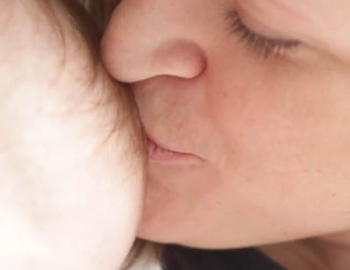 Mom kissing baby's head at Women's Care